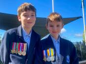 Dean Irwin (Year 6) and Aiden Irwin (Year 3) with their great grandfather's medals. Picture supplied