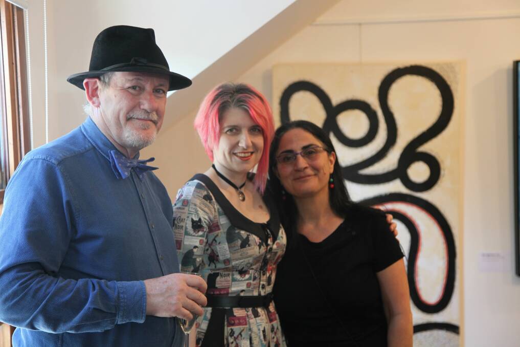 Locals Don Bone and Barbara Chies chat with artist May Ziade whose work has already been featured at the gallery.