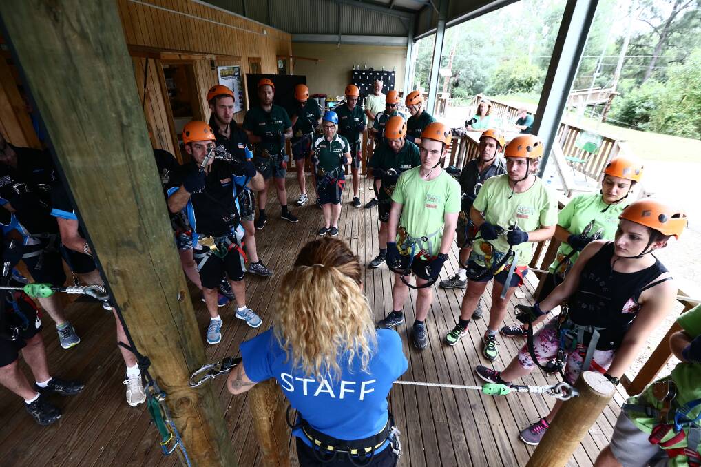 The teams are briefed on the rules before taking to the towering blue gums.