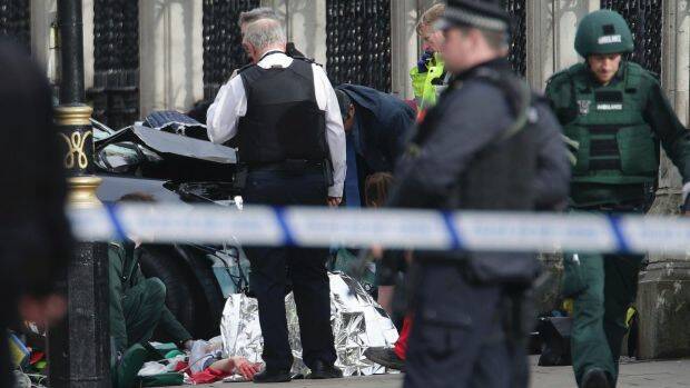 Emergency personnel tend to an injured person close to the Palace of Westminster, London. Photo: AP