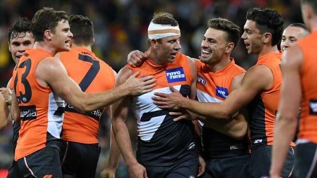 How the west was won: The Giants celebrate with veteran Steve Johnson (centre) after thrashing the Eagles. Photo: AAP