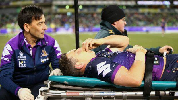 Awful sight: A concussed Billy Slater is assisted from the field. Photo: Getty Images