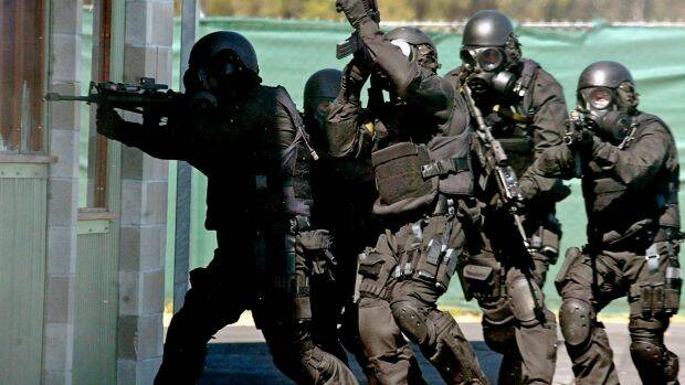 Members of the Tactical Assault Group storm a house during a counter-terrorism demonstration at Sydney's Holsworthy Army Base in a file photo. Photo: Reuters