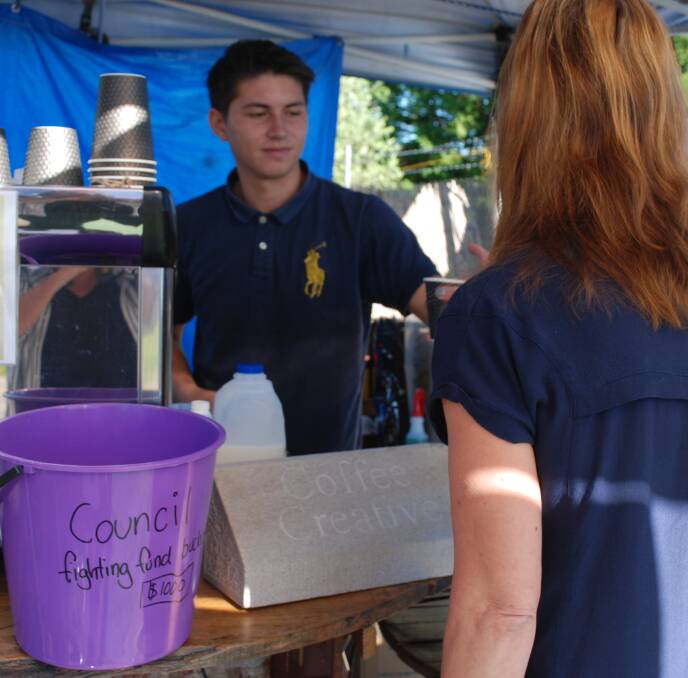 Crowd sourcing: Ash Bookluck serves coffee to a regular, Gail Pervuhin from Medlow Bath. The bucket is for donations to help pay for a development application.