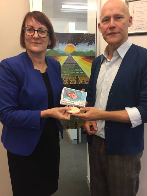Susan Templeman accepts a piece of dead coral from Paddy Connor of Stop Adani Blue Mountains.