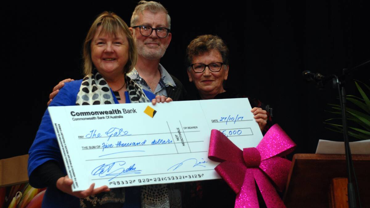 Donation: Adele Colman and Simon Hare with Rhododendron Festival president Elizabeth Giddey.