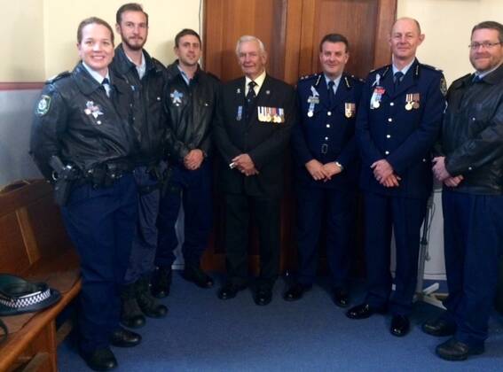 Local officers: Retired police commissioner Tony Lauer (centre) with members of Blue Mountains Local Area Command at the remembrance day service.