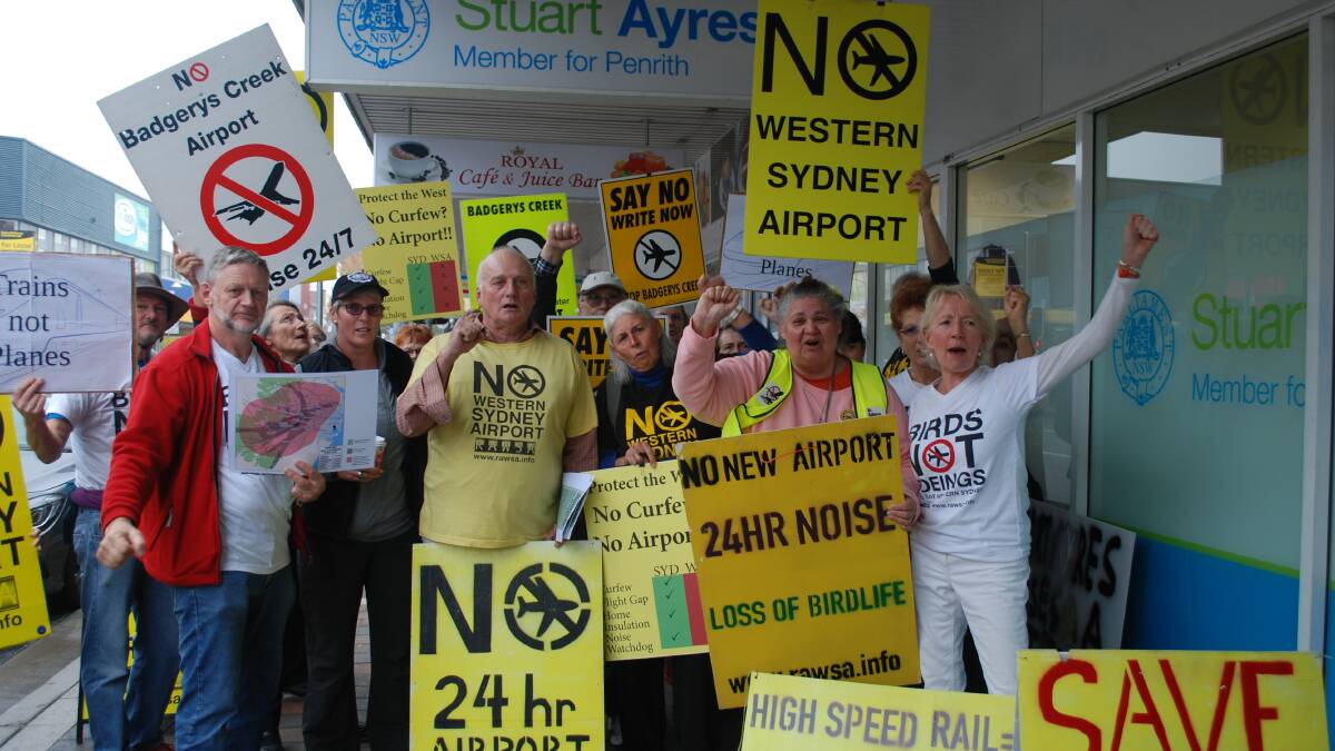 Janie Burry (in white at right) and fellow anti-airport protesters outside Stuart Ayres office on Friday.