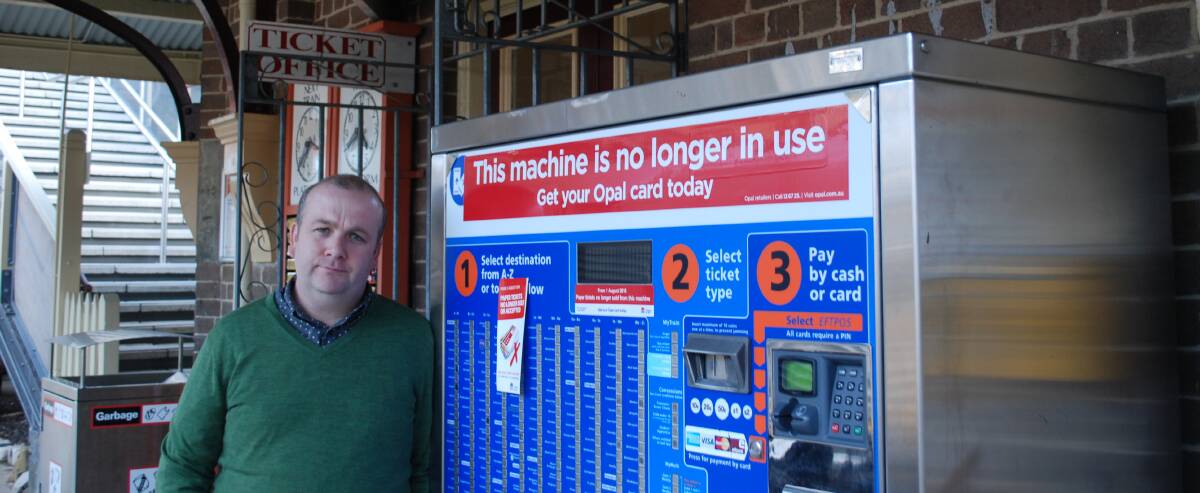 Out of action: Jonathan Llewellyn and the old ticket machine at Mt Victoria station. There is nowhere to buy or top up Opal cards at the station and several others on the Blue Mountains line.