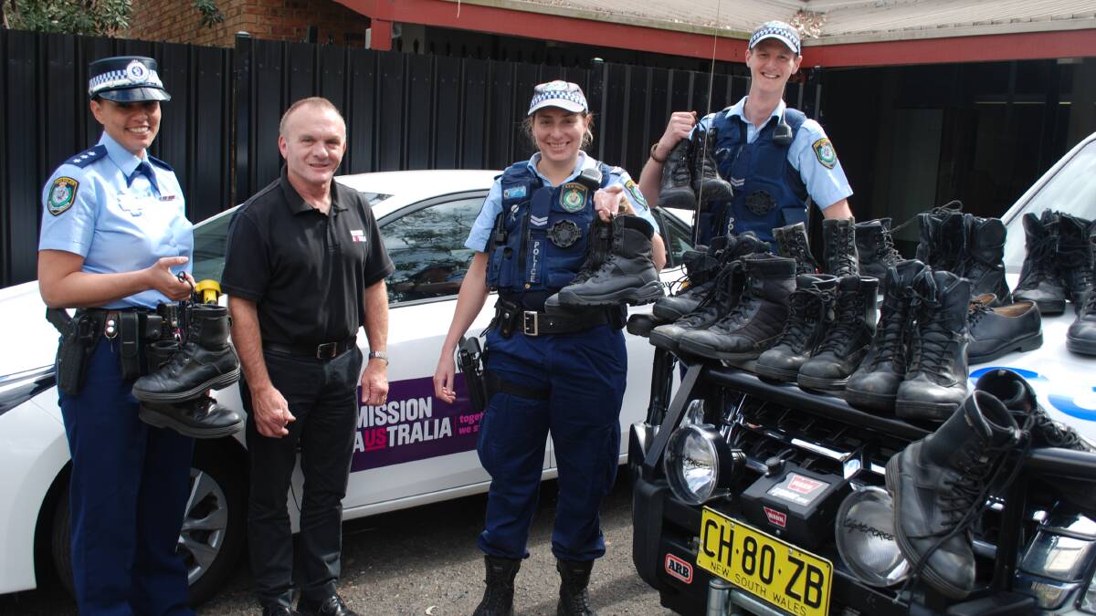 Boots to you: Acting Inspector Tracy Brickwood, Geoff Spicer from Mission Australia and Senior Constables Melissa Ellis and David Martin with some of the boots which will be handed out to charity.