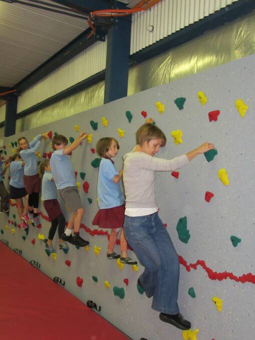Holding on: Teacher Sally Dare and pupils demonstrate their skills on Katoomba Public School's new climbing wall.