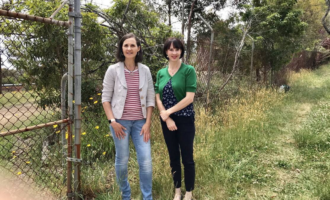 Much-needed facilities: Crs Romola Hollywood and Shae Foenander outside the vacant land on Loftus St, Lawson, which is slated for a paediatric clinic.