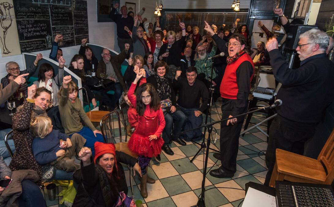 Piece of history: MC Pat Drummond (red vest) leads the call to Save the Wayzgoose building. Mark Alchin, the business's owner, is at right. Photo: Lee Doyle
