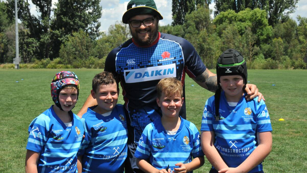 Some of the Blue Mountains Blue Tongue Lizards with NSW Waratahs player Angus Ta'avao at the camp in Armidale.