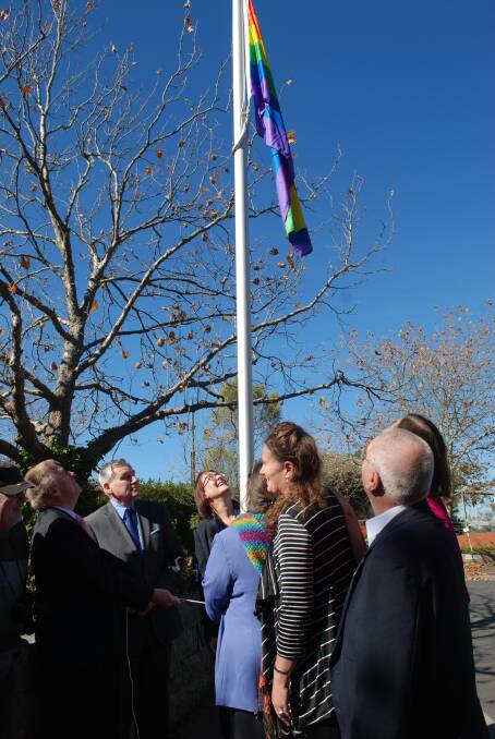 Retired justice Michael Kirby (left_ raises the rainbow flag outside council chambers in Katoomba at IDAHOT Day in May.