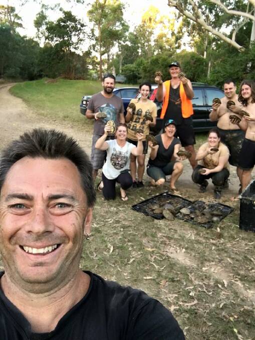 Dirty but happy: Shane Davies (front) with some of the turtle rescue team.