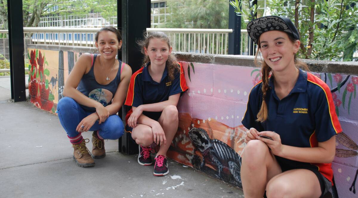 Becky Chatfield, school learning support officer and Sistaspeak co-ordinator, with students Celeste Arnold-Davis and Isabella Luken in front of the eastern water dragon.