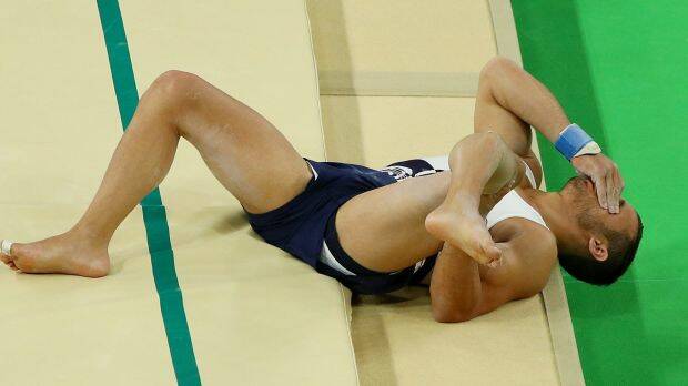 Samir Ait Said of France broke his leg while competing on the vault. Photo: Scott Halleran
