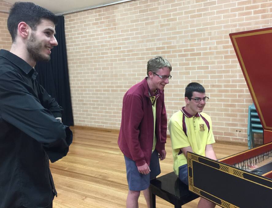 Nathan Cox with two Winmalee High students playing piano.