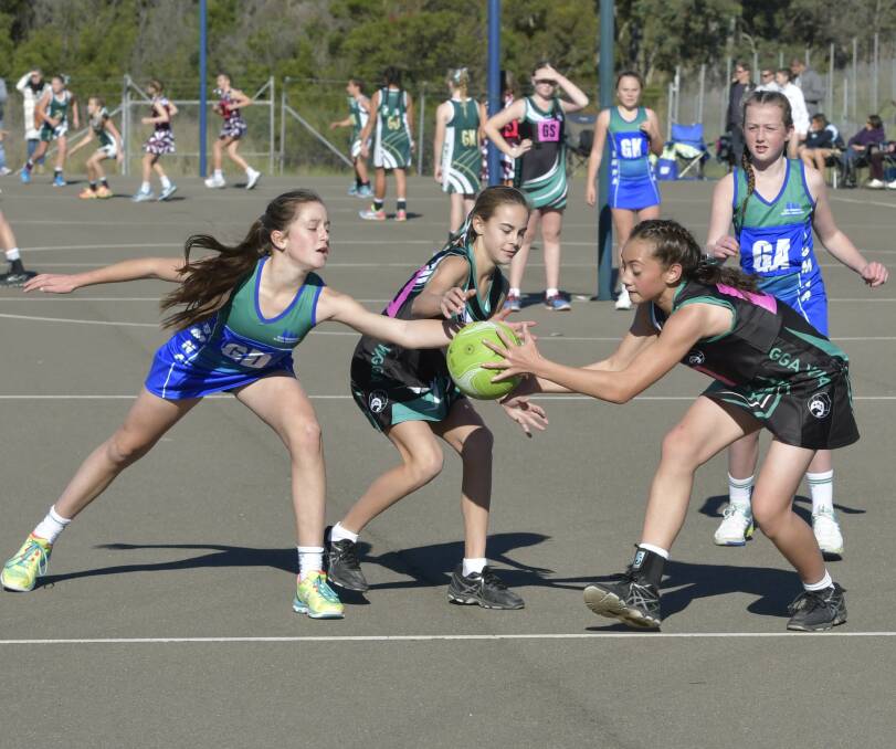 Ball grab: Blue Mountains 12/U netballers in action at the NSW State Age Championships. Photo: Nigel Owen