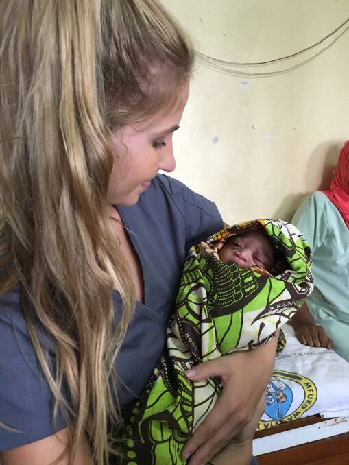 On the ground: Amy Houston in Tanzania with one of the babies to benefit from the care pack.
