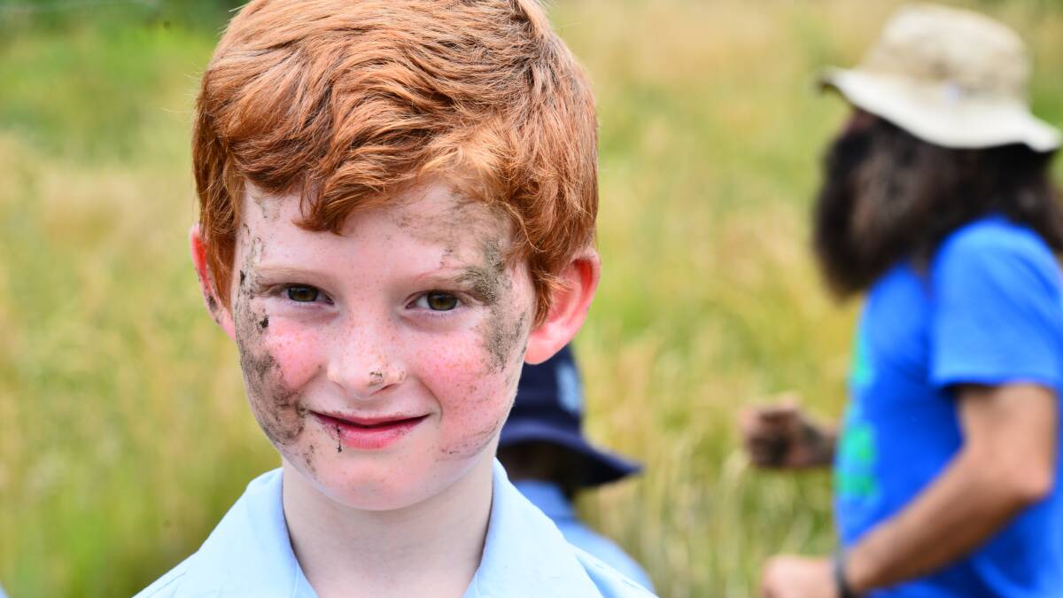 Fun but dirty work: Tree planting last December was a messy occasion for St Canice’s Catholic Primary School student Zac Lessing. Photo: Mark Geerligs