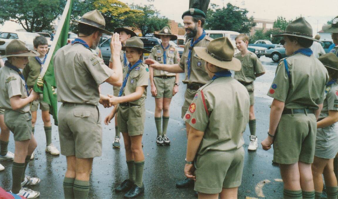 Part of the pack: Inducting a new scout in 1989 at the site of the old scout hall in Springwood.