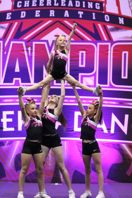 National champions: Taylor Brickwood, Kate Ford, Emma Brickwood and Emma Bardsley-Smith (in the air) from the junior level 1 stunt group.
