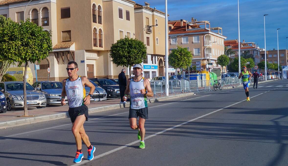 Top 10 finish: Brendan Davies (right) running in Spain at the 100km road world championships with Australian team-mate Barry Keem.