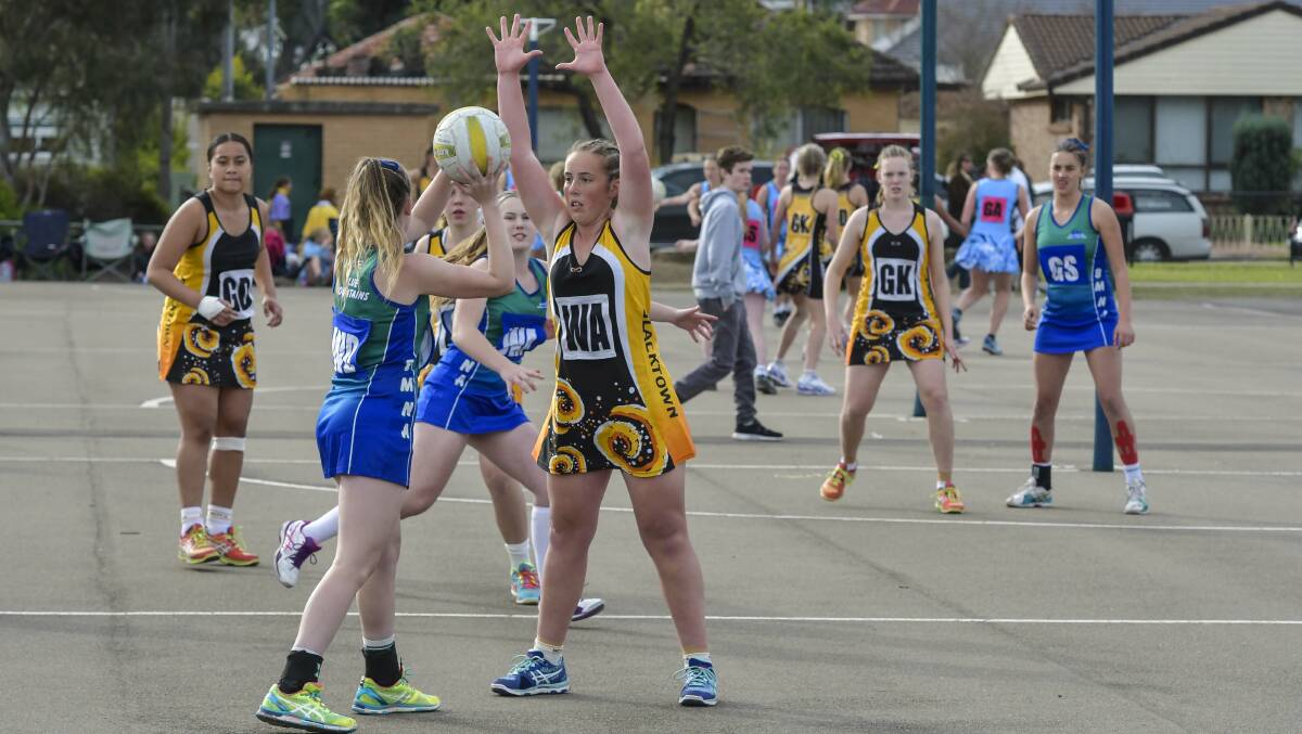 Up and over: Blue Mountains netballers in action at the NSW State Age Championships. Photo: Nigel Owen
