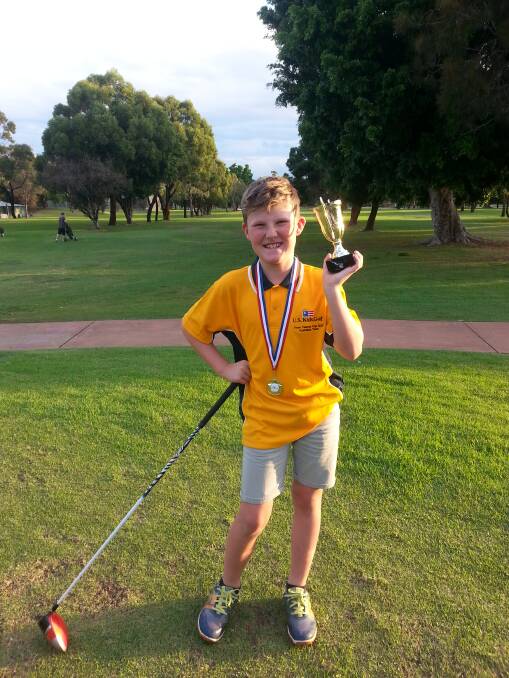 Golfing glory: Harry Daniels with the Trans-Tasman Championships winners trophy. Harry scored the winning putt for the Australian team to secure the championship. He heads to the US in August.