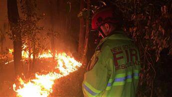 Well alight: Firefighters attend the Hawkesbury Heights scrub fire on Friday. Photo: Top Notch Video