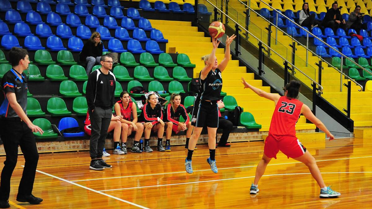 Aiming high: Dominika Offner (Springwood) launches a three-point shot against the Northern Suburbs Bears. Photo: Noel Rowsell (www.photoexcellence.com.au)