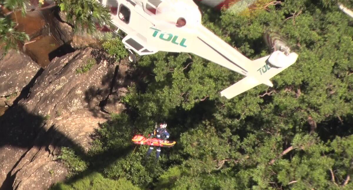 Rescue: Winching the injured woman out from Wentworth Falls on Sunday. Photo: Top Notch Video