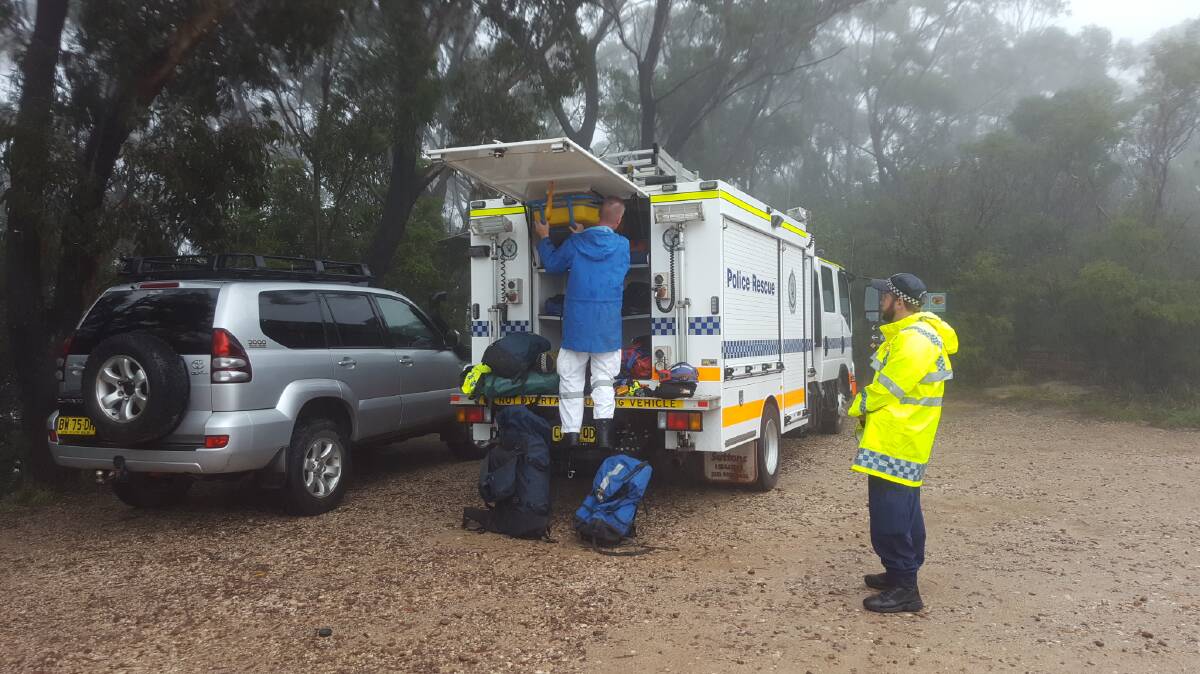Big fall in wet: Police go to the aid of a boy who fell 30m while hiking with a scouting group in Katoomba on Saturday. Photo: Top Notch Video