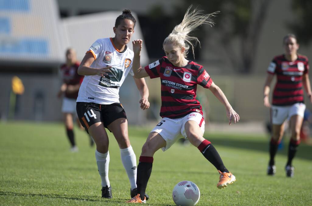 On the ball: A shot from last season of Brisbane Roar's Summer O'Brien applying pressure to fast-flying Western Sydney Wanderers W-League player Linda O'Neill. 
