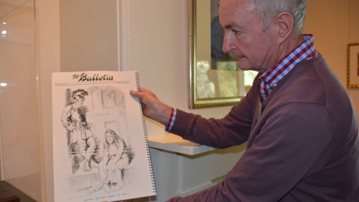 Gallery volunteer Paul Hardage with the March 12, 1947 Norman Lindsay cartoon.