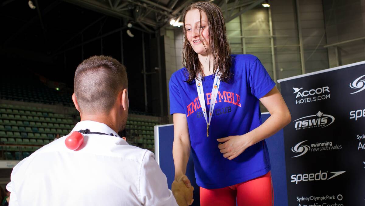 Super fast: Darian Quadrio accepts her medal after winning the girls 15 yrs 400m freestyle event at the State Age Swimming Championships. Photo: Nina Beilby