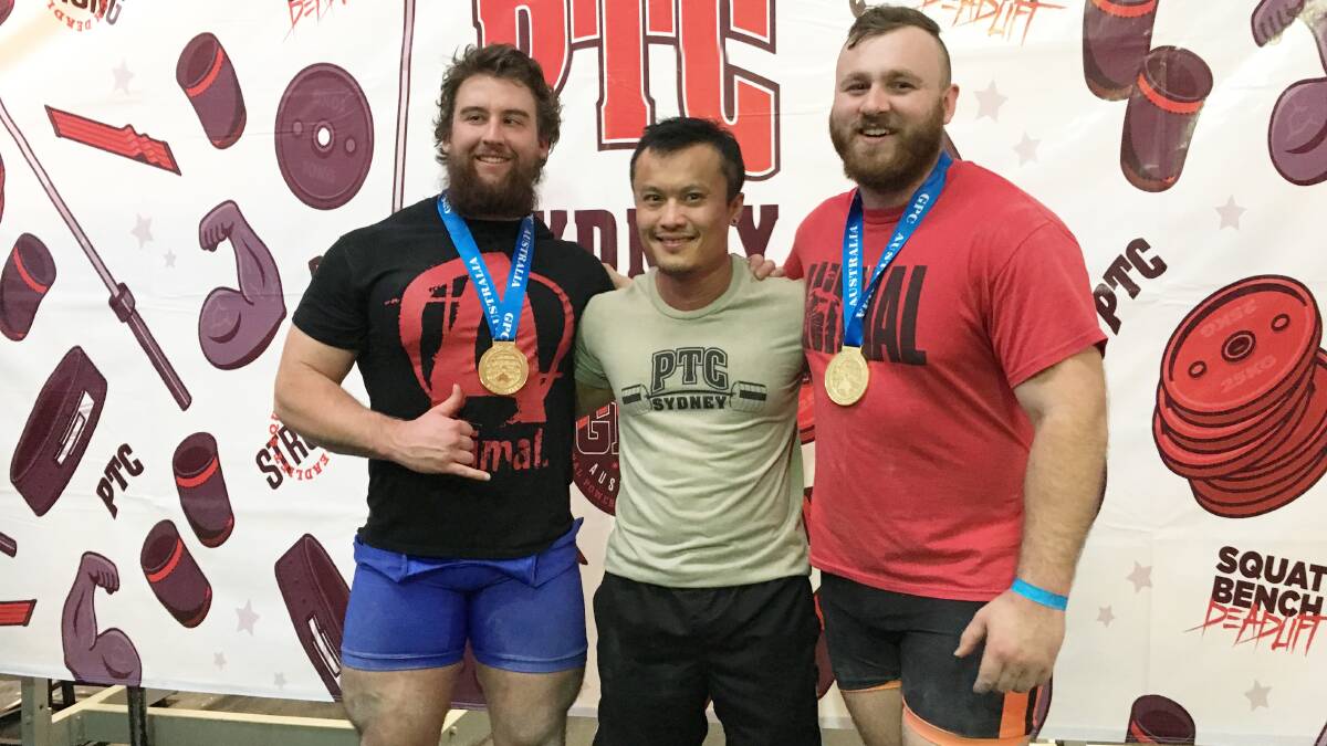 Powerlifters Kieran Brown, coach Trent Nguyen, and Clint Taylor.