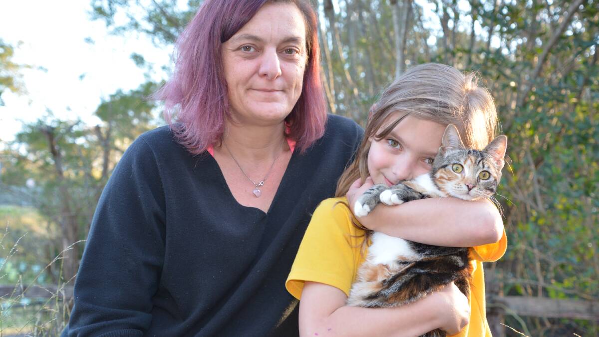 Sylvia Szabo and Poppymya Newman, 8, with cat Milo, who will be desexed through a subsidised desexing program provided by the RSPCA.