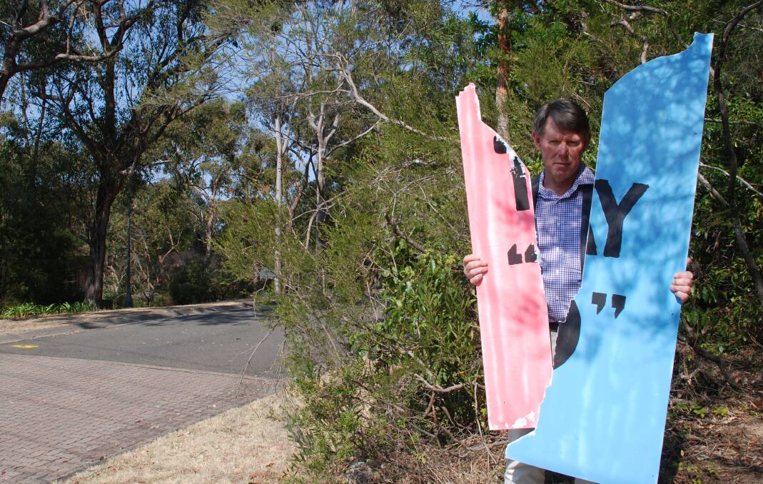 Targeted: Danny Wotherspoon outside his Faulconbridge home with the vandalised 'It's ok to say no' sign that was briefly displayed in his front yard.