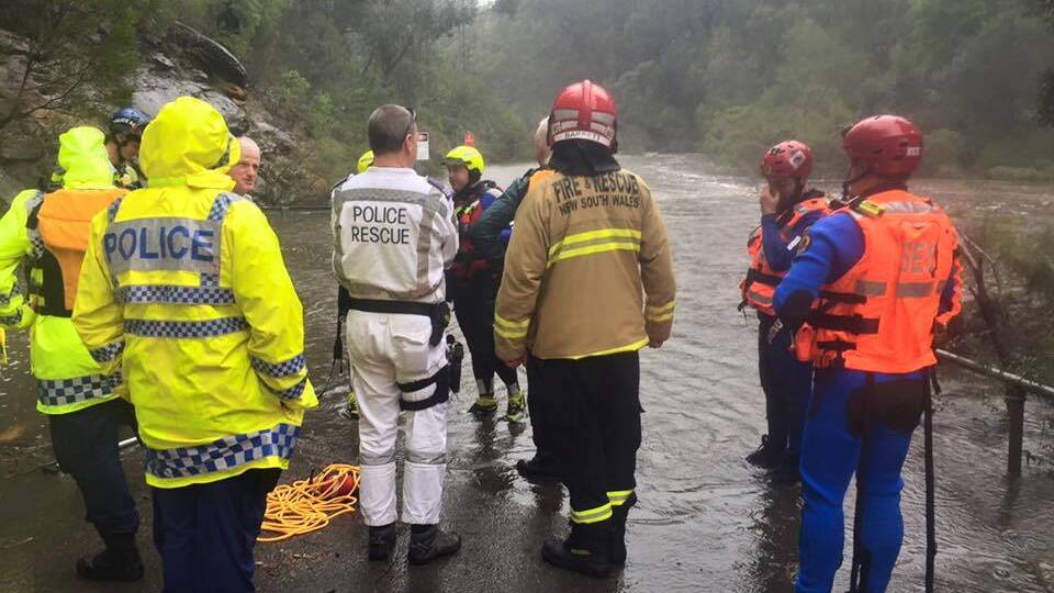 Extreme weather: NSW SES volunteer Andrew Bennett co-ordinates a flood rescue at Glenbrook National Park during heavy rainfall in June with NSW Police and Fire Rescue NSW.