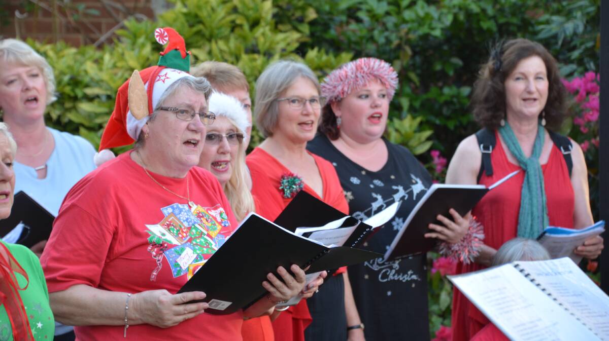 Sounds of the season: Carol singers outside the Springwood Presbyterian Church at last year's late night shopping event.