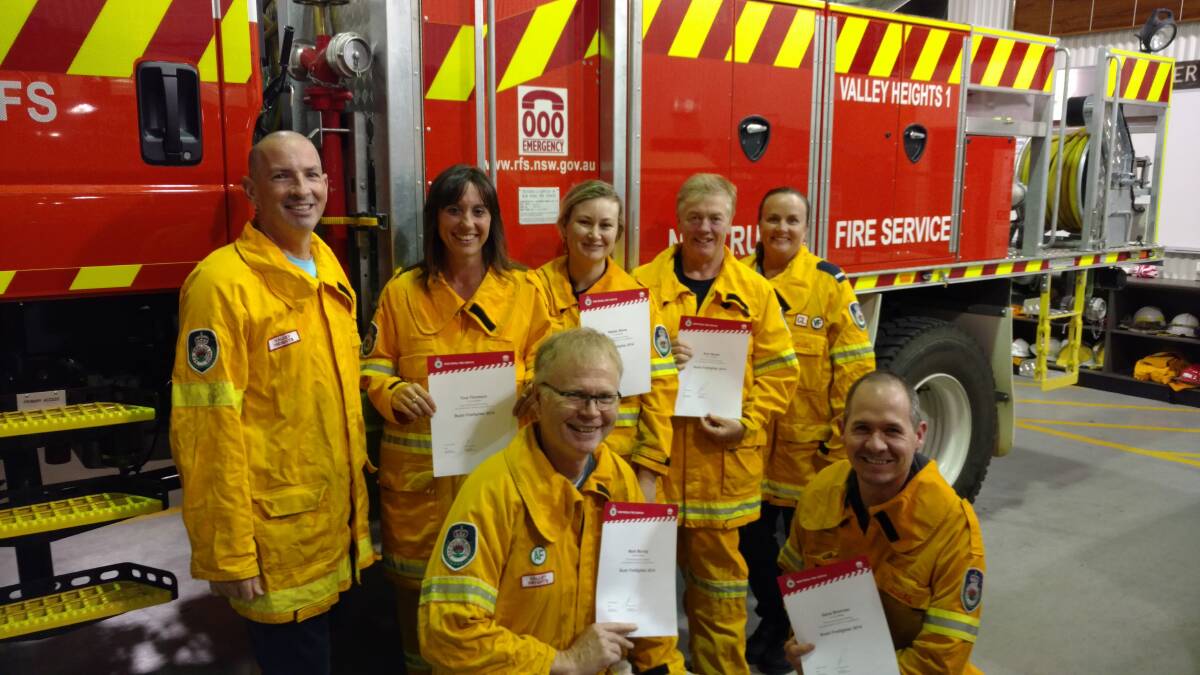 Valley Heights Rural Fire Service Brigade captain Peter Linnegar and deputy captain Bec Price congratulate Tina Thomson, Hayley Stone, Sue Hayes along with Mark Murray and Gene Brennan on achieving their bushfire fighter qualification.
