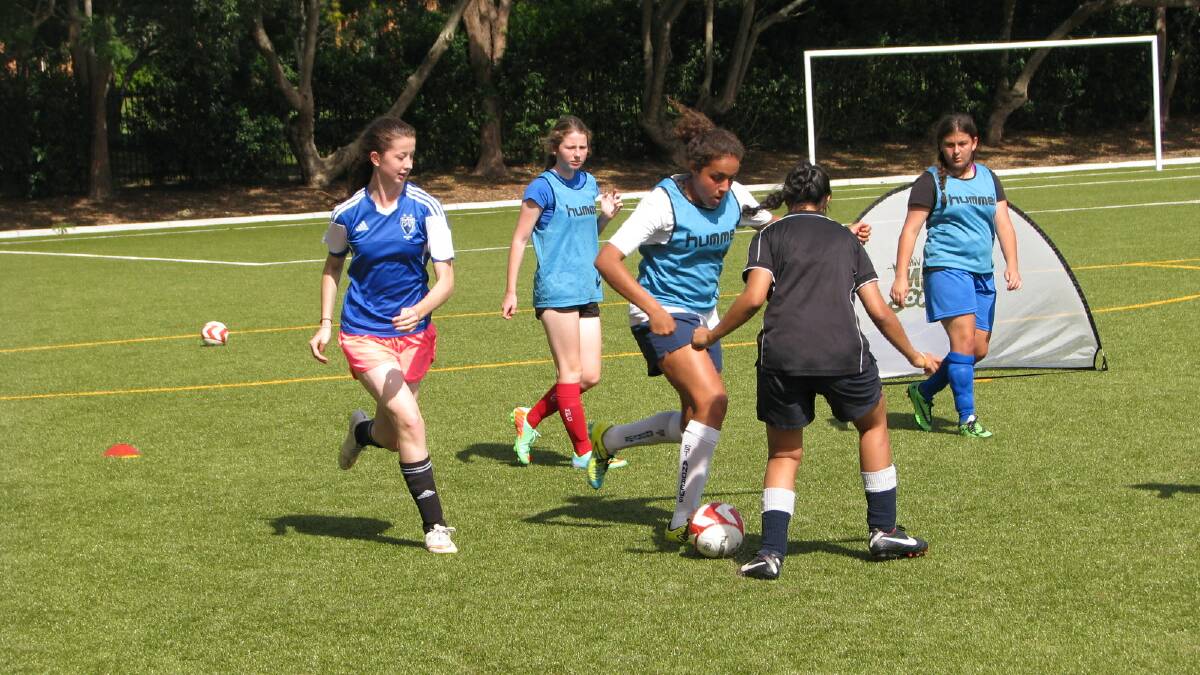 Girls taking part in a football development clinic.