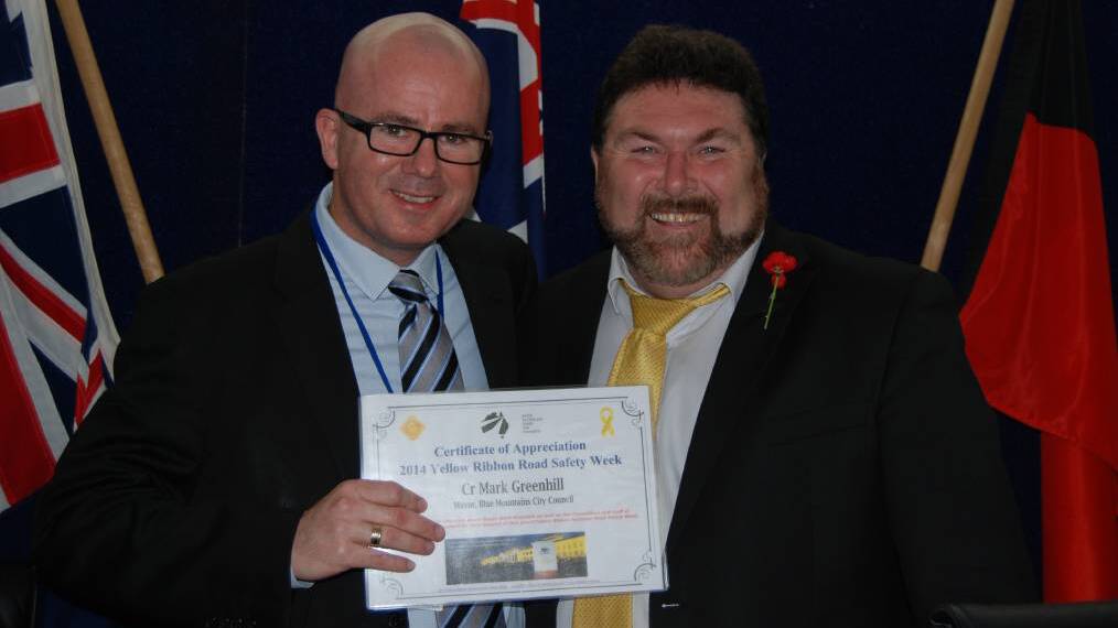 Show of support: Peter Frazer, SARAH President (right), presents Blue Mountains mayor Mark Greenhill with a certificate of appreciation for Blue Mountains City Council’s ongoing support of Yellow Ribbon National Road Safety Week.
