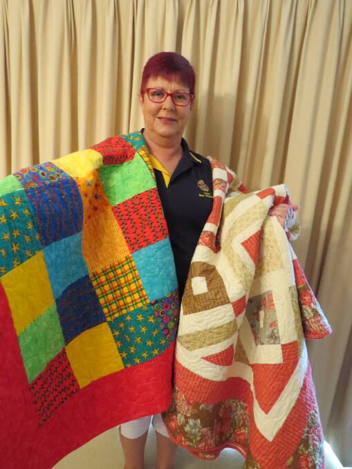 Giving: Sue Bell with some of the quilts for distribution to needy families in the fire-ravaged Uarbry area.