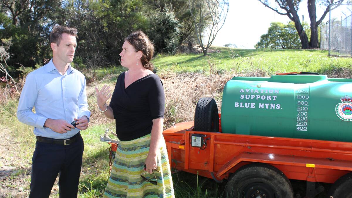 NSW opposition water spokesman Chris Minns and Blue Mountains MP Trish Doyle in Katoomba between the bushfire control centre and an empty lot owned by Sydney Water.