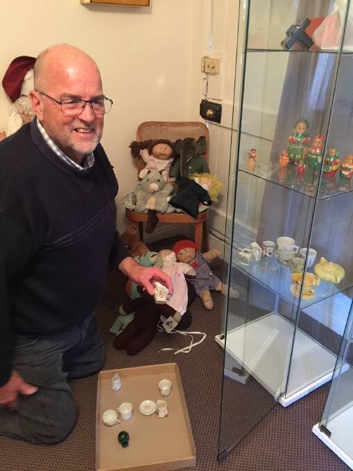 Ross Ingram sets up the toy exhibition at Tarella for the Blue Mountains Historical Society.