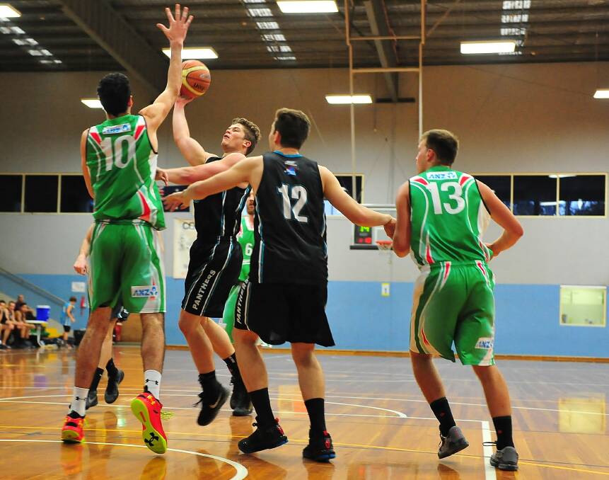 In form: Springwood's Tom Lewer scores in the paint against the Magic. Photo: Noel Rowsell (www.photoexcellence.com.au).